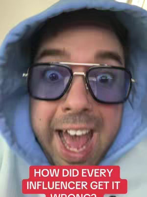 A selfie-style image featuring a man in a blue hoodie and large, blue-tinted glasses. He has a wide, surprised expression with his mouth open. A red bar at the bottom reads: "HOW DID EVERY INFLUENCER GET IT WRONG?"