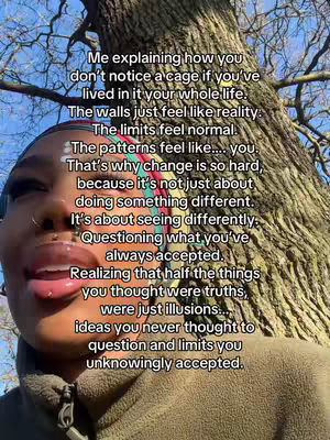 A close-up shot of a Black woman with a tree trunk in the background and overlaid text. The woman's face is angled towards the left, with her mouth slightly open. To the right is a large tree, filling the background with a mix of brown and green tones.