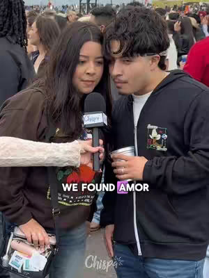 The cover image shows a young woman holding a microphone and interviewing a young man. Both are close together. The backdrop suggests an outdoor event, with a crowd of people blurred in the background. Overlaid text reads: "WE FOUND AMOR". The app logo "Chispa" is subtly present.
