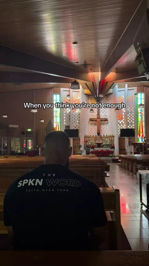 A man is seen from behind, facing toward the altar of a church. The church is brightly lit, with wooden pews in the foreground. Above the man, overlaid text reads, 'When you think you're not enough'.