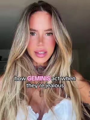 A woman with long blonde hair and pink makeup is looking directly at the camera. Text overlayed on the image says, 'how GEMINIS act when they're jealous.'.