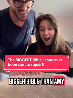 A man and woman are excitedly looking down at something. A red bar overlays the image with white text. Below it, black text is also displayed.