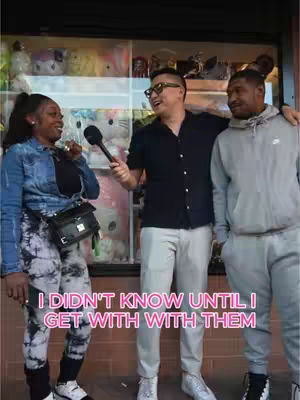 The cover image shows three people standing in front of a shop display. The person in the middle, a man with glasses, is holding a microphone and smiling. He has his arm around another man on his right, who looks like he's listening intently. On the left is a woman, also smiling, possibly responding to something. The background is filled with display items and store signage. The foreground has a pink text overlay reading, "I DIDN'T KNOW UNTIL I GET WITH WITH THEM."