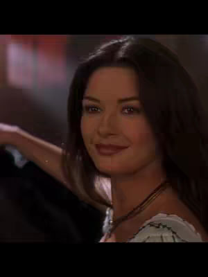 The cover image features a medium shot of a woman with dark hair, a subtle smile, and a hint of red lipstick. She appears to be looking slightly off-camera, with a background that is blurred, suggesting a focus on her face. She is wearing a white dress. The lighting seems soft and natural.