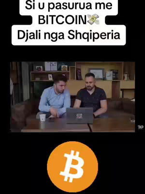 The image shows two men seated at a table, engaging with a laptop. Above them is a banner that contains white text, and below is a bitcoin logo in an orange circle.