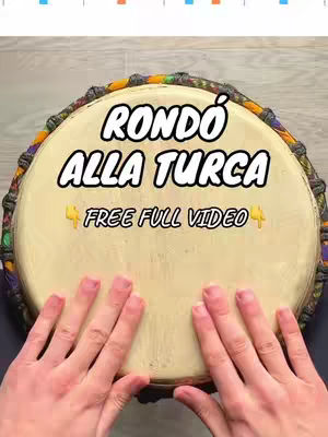 The cover image shows a drum with the text overlayed. The drum is round and has a light brown surface for the playing area. The text overlay is white and in a bold stylized font on a black background. The hands are both visible at the bottom of the image as they appear to be playing the drum. The colors are bright and attention getting.