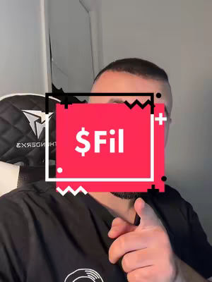 A man is pointing towards the camera with a red square overlaid covering his face. The red square has the text '$Fil' in white. The background includes a black and white gaming chair and a white wall.