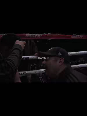 The cover image shows a scene from a boxing match. Two men are in the boxing ring, one man's face is visible in the foreground, wearing a black hat. The text 'DAMN IT' is overlaid onto the image at the bottom.
