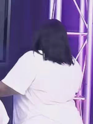 The cover image features a woman from the back. She has long, dark hair. She is wearing a white shirt. The background is an indistinct purple color with shiny metal. The composition is simple, focusing on the figure against a plain backdrop.