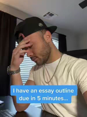 The cover image features a young man in a black cap and a white t-shirt with a silver chain. He is holding his head with his hand, looking down with a stressed expression. A blue rectangular text overlay at the bottom says, "I have an essay outline due in 5 minutes..."
