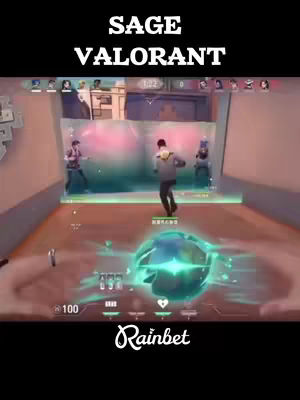 The cover image shows a first-person perspective from a video game, possibly Valorant, with the overlay text "SAGE VALORANT". The player's hands are visible in the bottom foreground, with a large green and blue orb in the center. Several animated game characters are visible throughout the screen. The Rainbet logo is displayed at the bottom of the screen.
