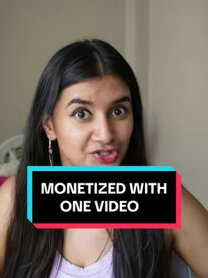 A woman with long black hair and a light purple top is shown, looking directly at the camera with a slightly surprised expression. A rectangular text overlay in black with a blue and red outline is positioned in front of her, displaying the message "MONETIZED WITH ONE VIDEO."