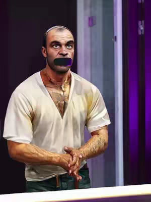 An AI-generated image featuring the character Trevor Philips from Grand Theft Auto V. He is depicted from the chest up with his hands clasped in front of him. His mouth is covered and the background features a door, and purple accents.