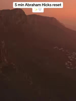 The image shows a scenic landscape with mountains silhouetted against a vibrant sunset. Text overlayed on top reads '5 min Abraham Hicks reset'.