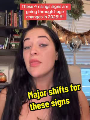 A woman with long dark hair looks up with a serious expression. The background includes a bookshelf and decorative items. Text overlays in the top and bottom portions of the image add information. The overall composition uses a head-and-shoulders shot with a medium depth of field, with the woman as the primary focus.