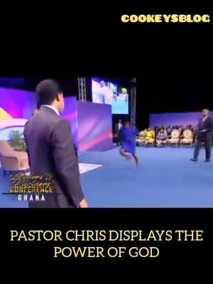 The cover image shows a stage with a man in a suit looking towards the left, while another person is jumping in the air to the right. The background has a large screen displaying another image, and there are several people seated. The bottom of the image displays the text, 'PASTOR CHRIS DISPLAYS THE POWER OF GOD'.