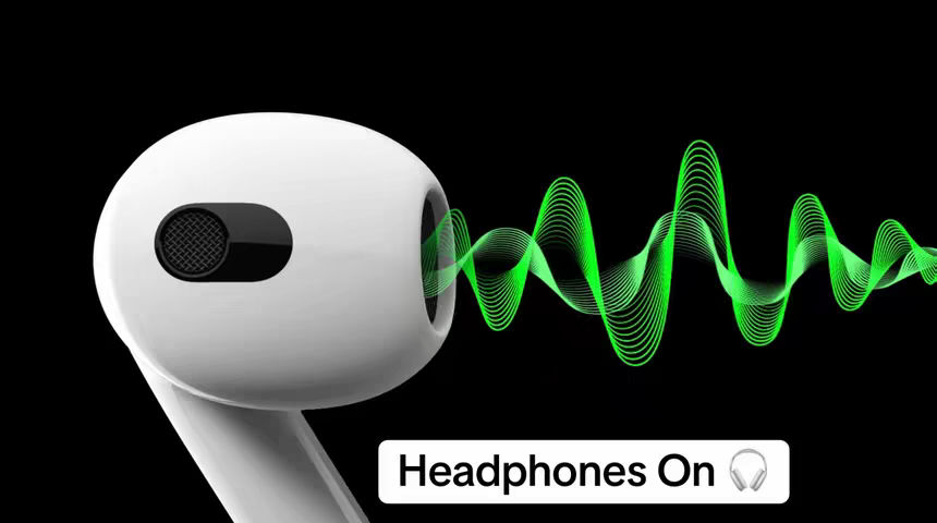 A 3d rendering of a white earbud with soundwaves coming from the speaker, overlayed on a black background. The sound waves are a bright green color and curve across the image. A white rectangle at the bottom of the image contains the text "Headphones on" and a small headphone icon.