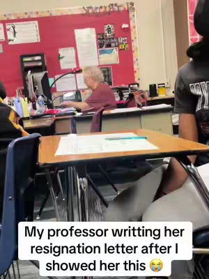 The cover image shows a classroom setting. A professor is sitting at her desk in the background, appearing to work on something. In the foreground, a student's desk and chair are visible. Along the bottom of the image, there is a white rectangular text overlay.