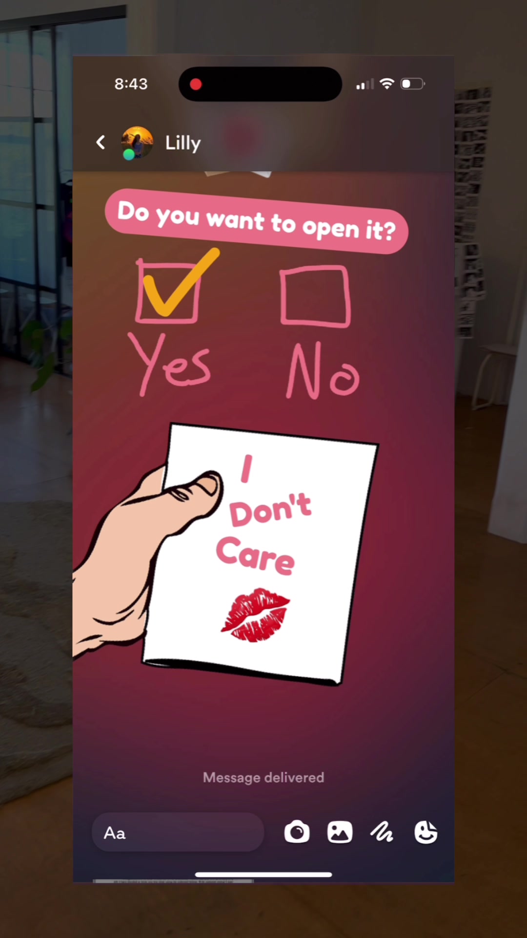 The image appears captured from a phone screen, showing an app interface with a chat-like format. The background is gradiated from a darker, cooler tone towards the top of the screen to a warmer tone lower down. At the top, there's a status bar with the time and signal indicators. A message bubble is visible in the center showing a hand holding a card that reads "I Don't care", which is a white rectangular board with a red lipstick mark at the bottom, while the text is in red. Above the card, are rectangular options, a green tick showing that you agree and want to move on while the other option to the side, is empty and it says 'No' nearby. There is an input at the bottom to enter in text.