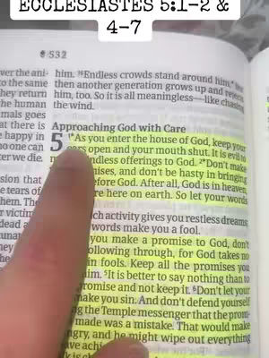 A hand points at a highlighted passage in what appears to be a Bible. The text is spread across two pages, with the focus on a highlighted section.