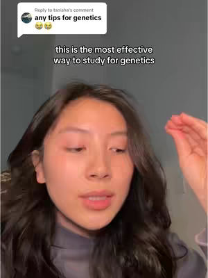 A young woman with long, dark wavy hair is centered in the frame, gazing directly towards the viewer. The background is a soft, blurred environment with hints of a wall. Overlayed are a comment bubble from `tanisha's comment`, and text at the bottom of the comment saying `any tips for genetics`, in a white, sans-serif font, along with two emojis. Below the text is the main hook to the video in a black, sans-serif font.