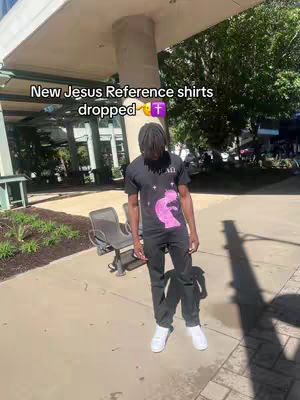 A person wearing a black t-shirt and black pants stands in front of a building. A hook appears on the cover image, with the overlaying hook text at the top. The person is near a set of benches made of metal. The background reveals a sunny pathway with trees and a building.