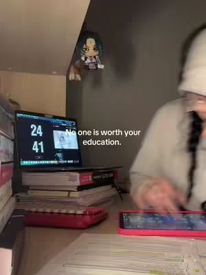 The image shows a person studying at a desk, with a laptop displaying a timer, books, a keyboard, and a phone. A plushie is on the wall near the laptop and the text overlay states "No one is worth your education."