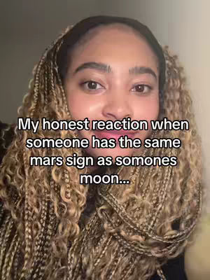 A close-up shot of a woman's face with long, blonde braids. Text overlay the the image says 'My honest reaction when someone has the same mars sign as somones moon...'. The background is a soft, blurred beige.