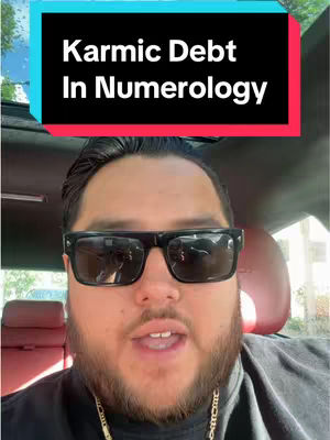 A selfie-style shot of a man in sunglasses inside a car. A text overlay at the top reads "Karmic Debt In Numerology". The man has short hair and a beard. The background includes a car interior and a glimpse of the outside.