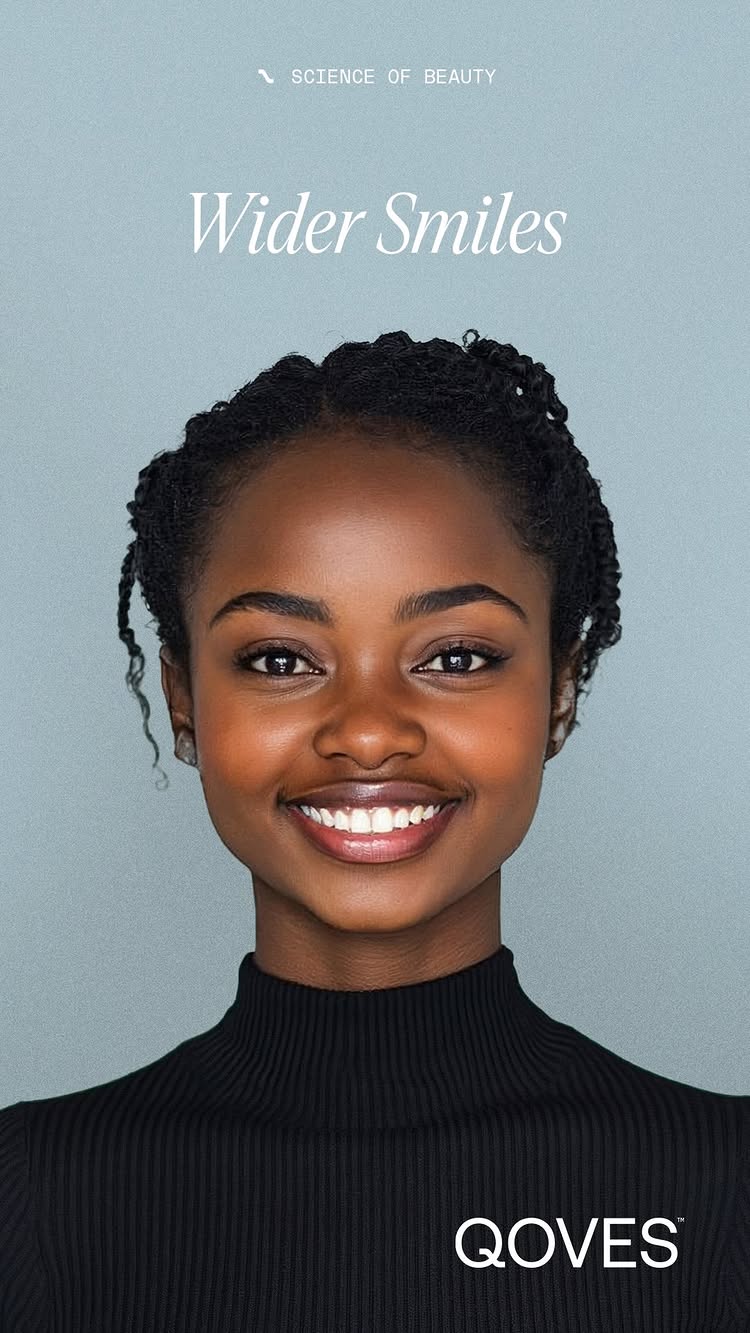 A studio portrait featuring a young Black woman with a wide, inviting smile. She has dark, neatly styled hair, and is wearing a black turtleneck. The background is a solid, pale teal color. Text in a clean, sans-serif font overlays the image, reading 'Wider Smiles' and 'SCIENCE OF BEAUTY' at the top. The QOVES logo is at the bottom.
