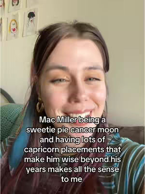 A woman with light brown hair is the subject of the image. She is smiling widely at the camera. There are earrings, and the background is a room, with some art hung on the wall. Text is overlaid on the image.