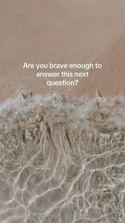 The image background presents a beach scene. The top portion of the image shows a light brown sandy area and the bottom of the image shows the clear water with waves. In the center, a white text overlay reads, "Are you brave enough to answer this next question?"