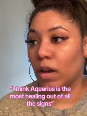 A close-up shot of a woman's face, with the focus on her expression and a text overlay. The woman has dark hair pulled up in a bun, with long eyelashes and visible makeup. Text in a pink-red gradient color overlayed at the bottom of the image.