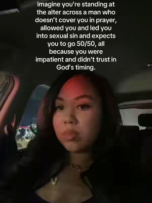 A woman in a car looking at the camera with a message overlayed in the image. The lighting suggests it might be night time.