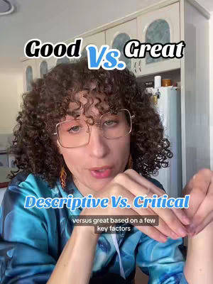 A woman with curly hair and glasses is centered in a selfie-style shot. The background shows a kitchen setting with white cabinets. Text graphics overlay the image, with phrases such as 'Good Vs. Great' and 'Descriptive Vs. Critical.' She seems to be talking, possibly explaining or giving advice, with her hands visible near her chest.