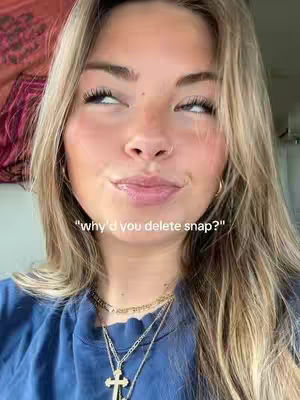 A young woman with long blonde hair, wearing a blue top and multiple layered necklaces. Her eyes are looking up and slightly to the left, with a questioning expression. A text overlay reads, "why'd you delete snap?"