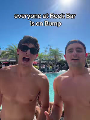 Two young men are standing in front of a swimming pool, with palm trees visible in the background. The man on the left is wearing sunglasses and has his mouth open. Text overlaid on the image reads 'everyone at Rock Bar is on Bump'.