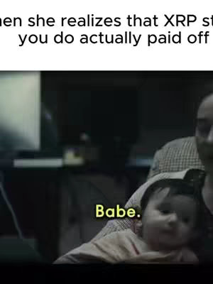 The cover image is a still from a video with a dark setting. A person is holding up a baby. The baby has a soft peach-colored outfit on. A text overlay in a yellow box reads 'Babe'. The upper part of the image has some text, but it is cut off.