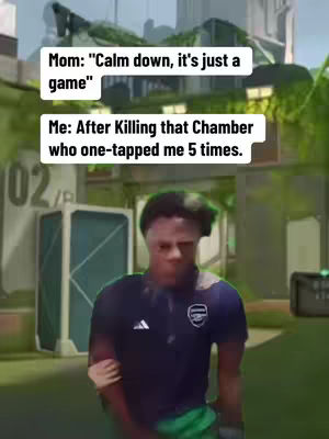 A person in a dark blue shirt with an Arsenal logo is standing in front of a blurred background. Above his head are two text boxes with white text on a black background, with a green and gray building scene, and green foliage in the background.