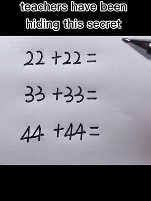 The image shows a sheet of white paper on which a series of math problems are written in black. The problems involve the addition of two-digit numbers where the digits are identical (22+22, 33+33, 44+44). The text is handwritten, and the overall composition is simple and direct, emphasizing the math equations
