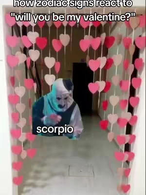 The cover image shows a horror figure, possibly inspired by the character Art the Clown, framed within a Valentine's Day-themed setting. The scene is a hallway decorated with rows of pink and red heart-shaped decorations, suggesting a romantic or possibly unsettling contrast. The figure, a person with a clown-like face, including white makeup, a black spot on his head and dark eye makeup, is displayed on the visible lower portion of the display. The text 'scorpio' is placed underneath his face near the bottom of the image. The overall composition creates a juxtaposed effect, combining the sweetness of Valentine's Day decorations with the ominous presence of the character.