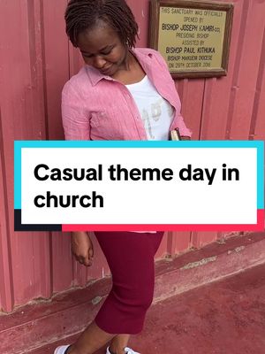A woman stands in front of a red wall with religious text, wearing a pink shirt over a white t-shirt and a burgundy skirt. Text overlaid highlights her casual attire and the church setting.