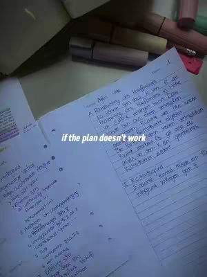 The image displays an open notebook on a desk with notes written in blue ink. Text overlayed says: "if the plan doesn't work". There are highlighters and other stationary in the background.