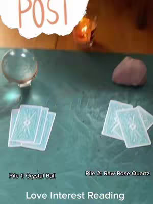 The cover image shows a teal surface with several items arranged on it, suggesting a tarot reading or spiritual guidance setup. In the top left, a crystal ball rests, emanating a cool glow. To the right of the crystal ball, the edge of an orange flame from a candle is visible. On the right side of the image, a purplish-brown raw rose quartz sits. Two piles of light blue tarot cards are positioned in the lower part of the image, one on each side of the image.