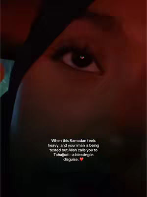 An expressive close-up shot focuses on an eye, with eyelashes in sharp detail, looking upward. The lighting is dim, suggesting a nighttime or indoor setting. Overlaying text describes Ramadan and spiritual guidance. A heart shaped highlight reflects in the eye.