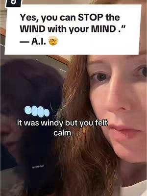 A selfie-style video cover features a woman with auburn hair, facing slightly to the side. A text overlay with a white background appears in the top section, quoting 'Yes, you can STOP the WIND with your MIND.' It also includes '- A.I.' The bottom of the overlay is a text 'it was windy but you felt calm'. The rest of the cover image is the woman's face and part of a screen.