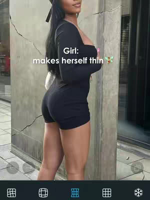 A woman in a black romper stands angled towards the camera against a concrete wall. The words 'Girl: makes herself thin' are overlaid in white text.