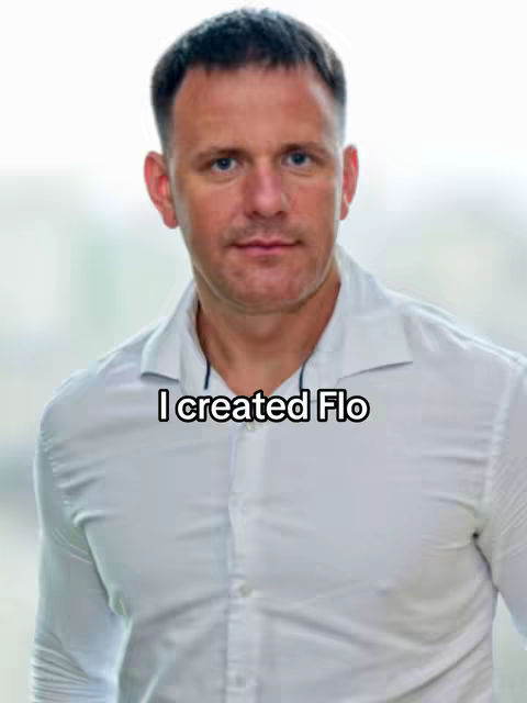 A man in a white shirt looks directly at the camera against a softly blurred background. Overlaid on the image is the text 'I created Flo' in a black, simple font.