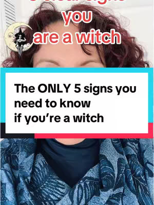 The image is a vertical video cover featuring a woman's face and upper torso. She has abundant, curly red hair. Overlaid on her face are the words "you are a witch" in a red, outlined font. Below this, the video's hook text, "The ONLY 5 signs you need to know if you're a witch" is displayed in a blue rectangular box with white lettering. The woman's upper body is visible, wearing a blue patterned jacket. The background is a plain white.