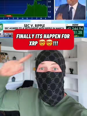 The image is a selfie-style shot with the creator's face taking up the central part of the frame. The creator wears a Gucci patterned balaclava, and only their green eyes are visible. They are pointing their right index finger upwards to the left of the frame. In the upper area are graphics with stock charts along with a news broadcast segment. A large red rectangle with white text overlaps part of the frame, adding the video's message.